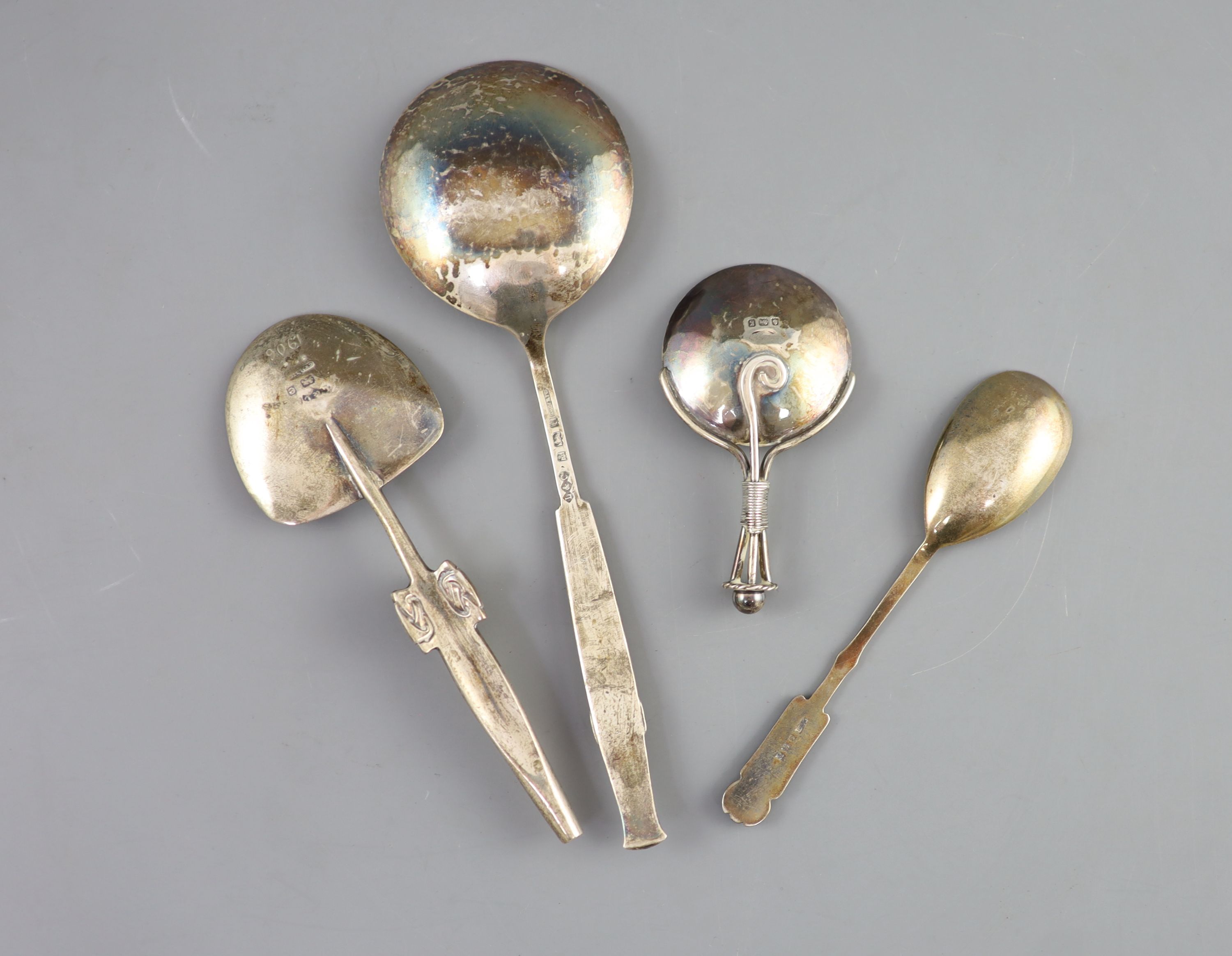 Two stylish Edwardian Art Nouveau Liberty & Co Cymric silver spoons, Birmingham, 1904, largest 18.6cm and two other spoons